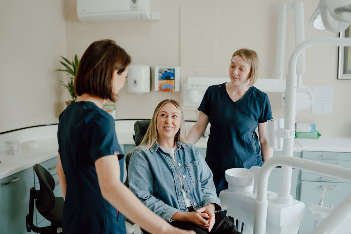 Two members of the Cherrybank clinical team with a patient in a treatment room