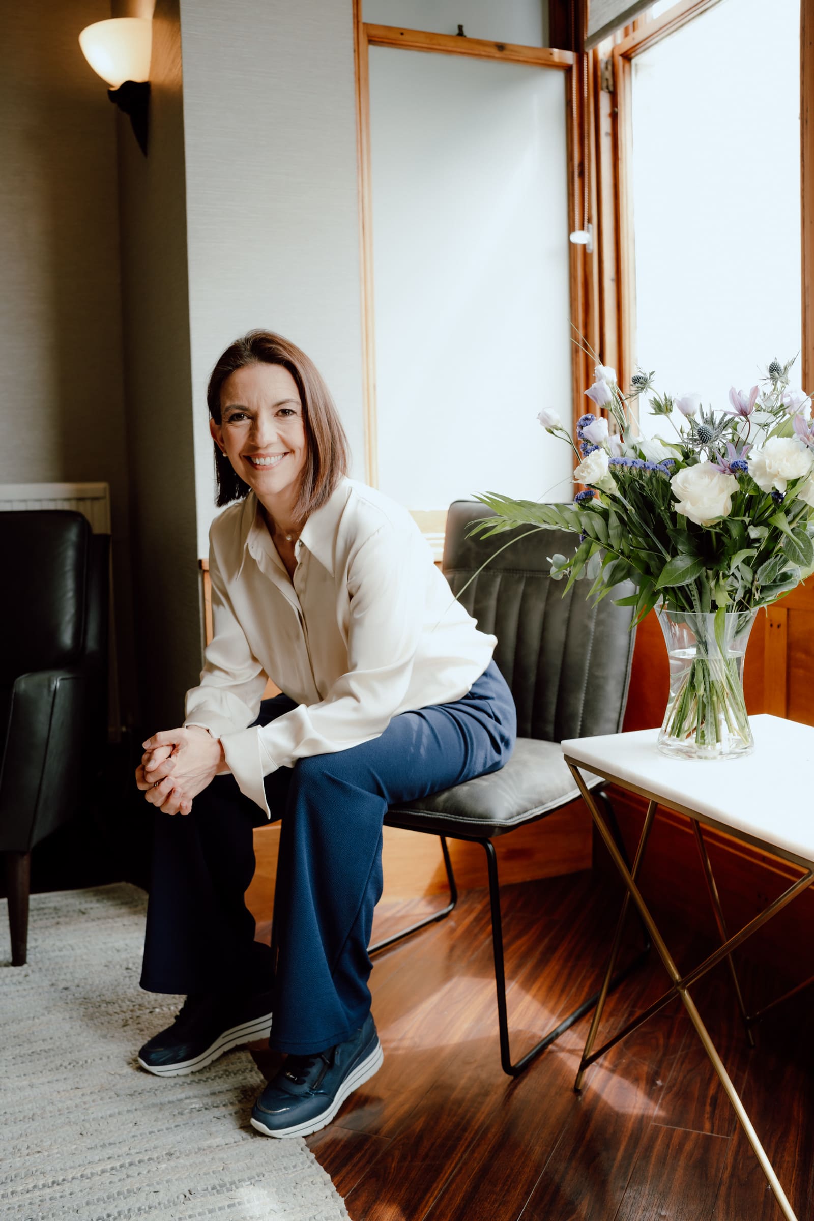 Dr Elaine Halley seated in the patient lounge at Cherrybank Dental Spa